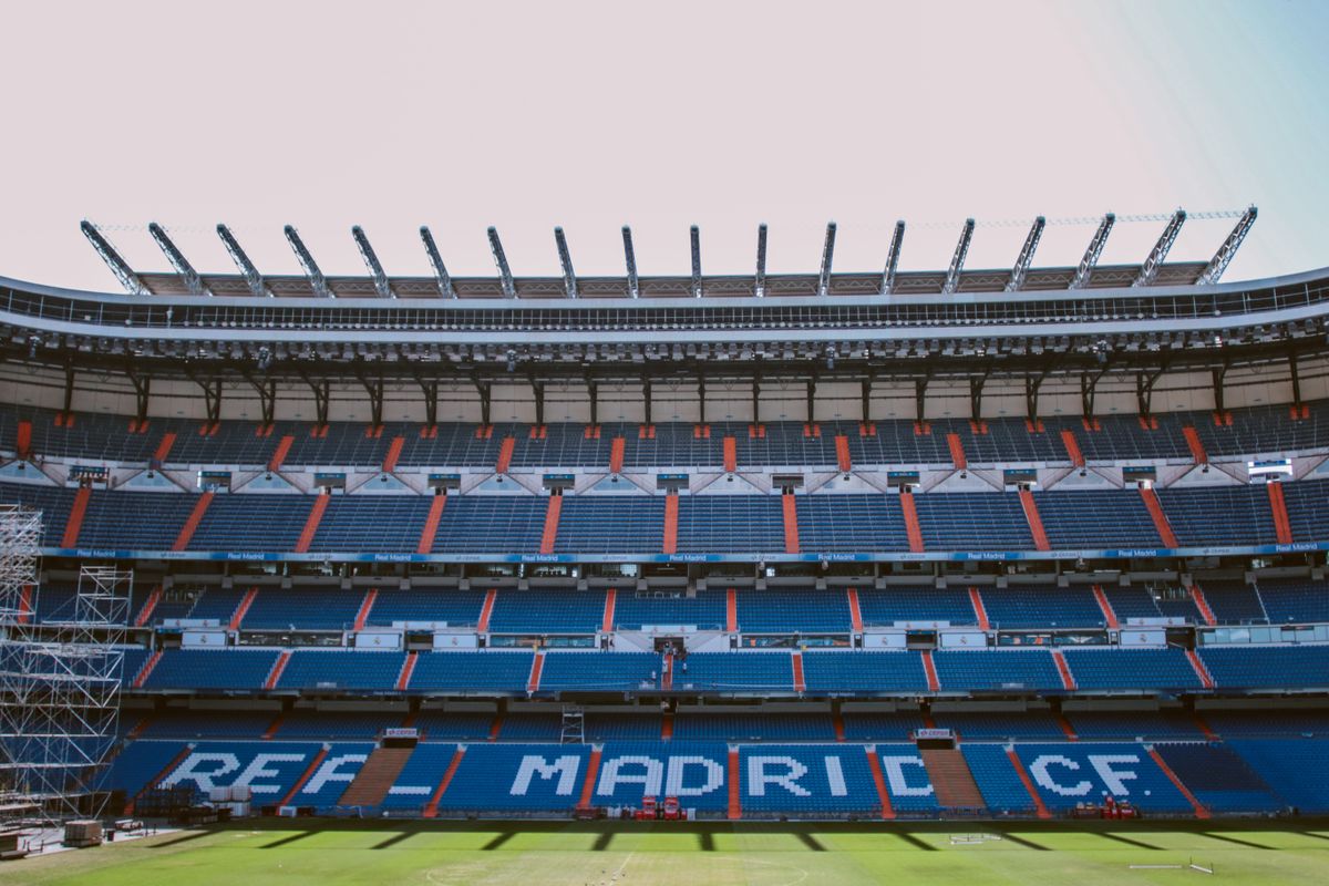 Stadion olahraga dengan lampu sorot menyala di malam hari